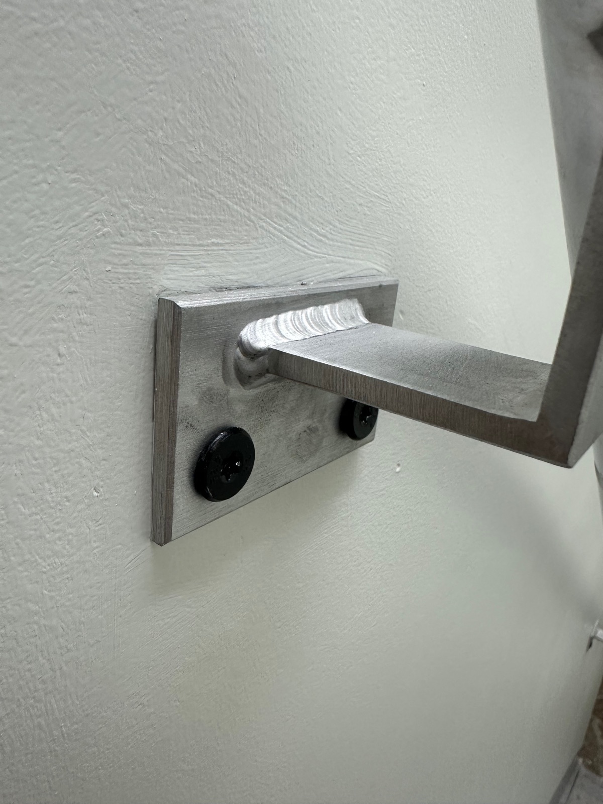 Weld detail on a fabricated handrail wall bracket