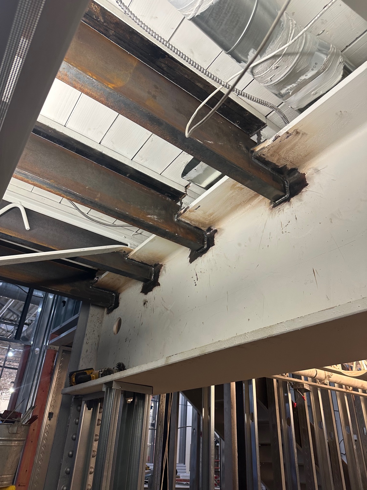 Structural steel beams welded into place during an interior build-out